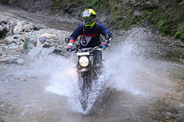 Triumph Scrambler Wading Through Water Front Profile