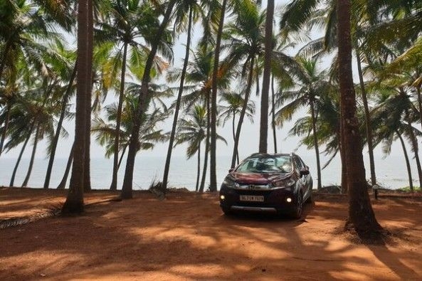 Red Color Honda WR-V Front Profile Among Trees