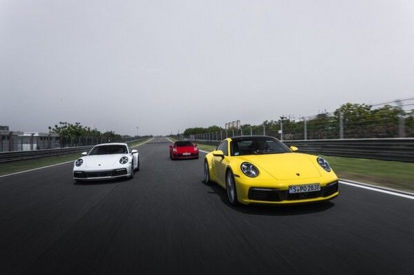 Yellow Color Porsche 911 Carrera S Leading Other Porsche Cars in Track Race
