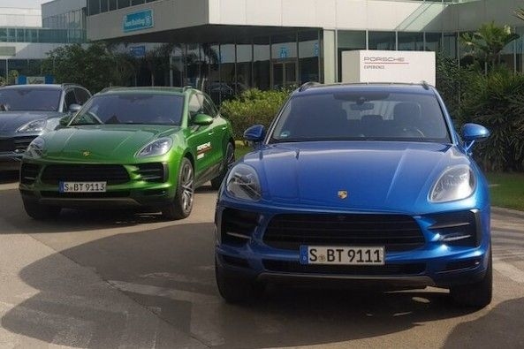 Green and Blue Color Porsche Macan Adjacent to Each Other Front Profiles